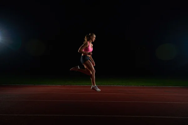 Athletic woman running on track — Stock Photo, Image