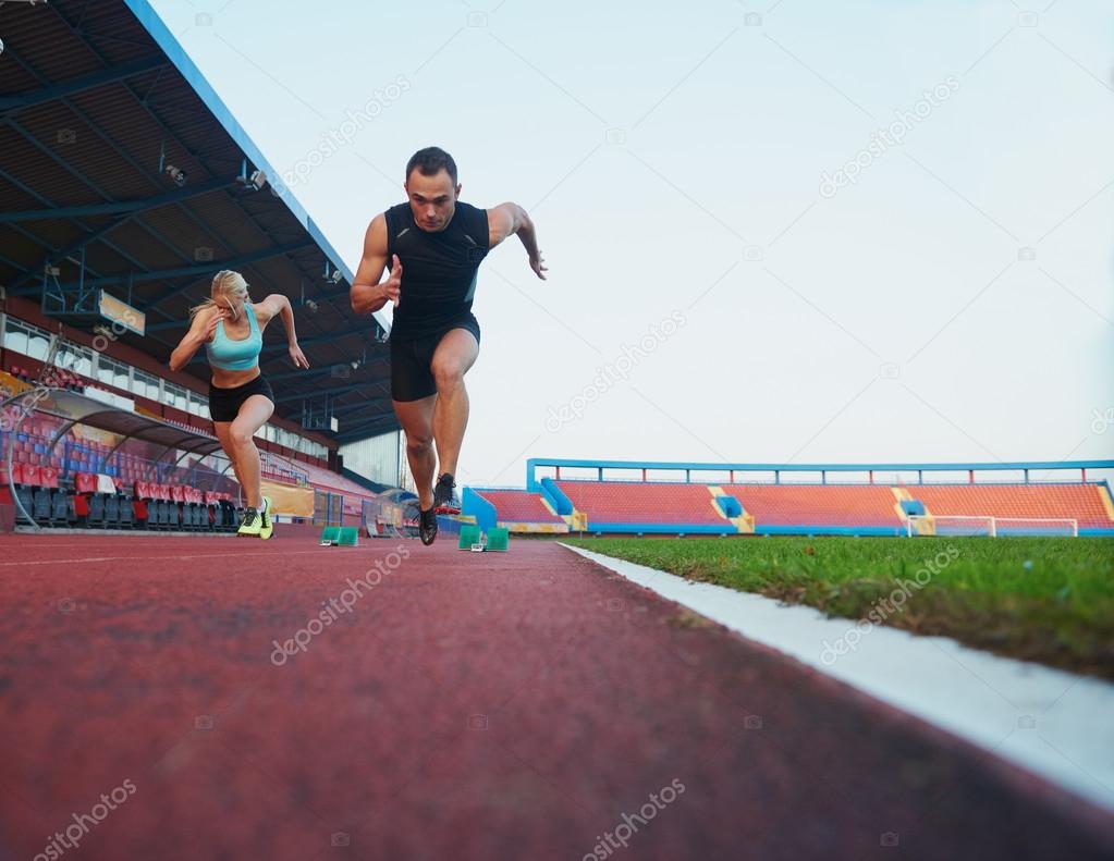 sprinters leaving starting blocks