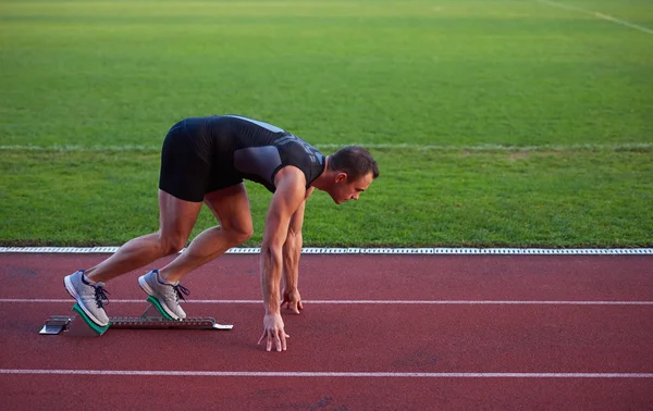 Athletic man at start — Stock Photo, Image