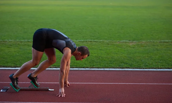 Athletic man at start Stock Picture