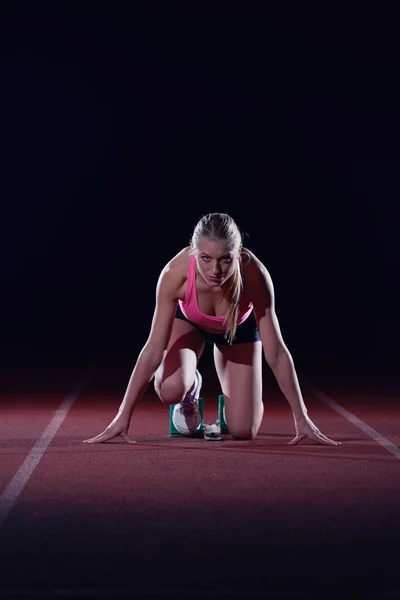 woman  sprinter leaving starting blocks