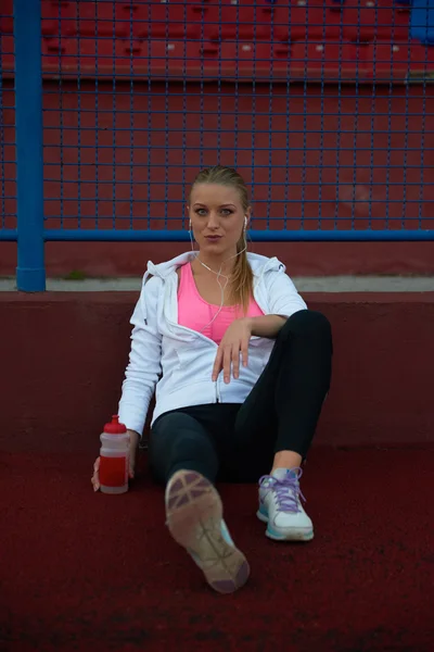 Sporty woman on athletic race track — Stock Photo, Image