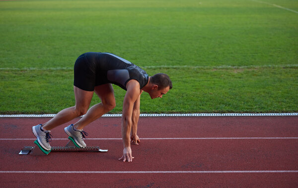Athletic man at running track.