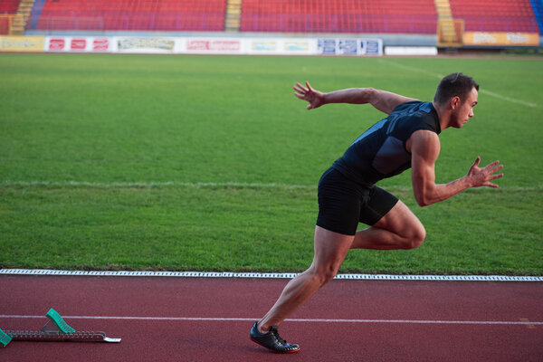Athletic man at running track.