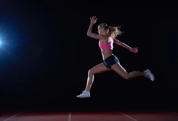 Athletic woman running on track — Stock Photo, Image