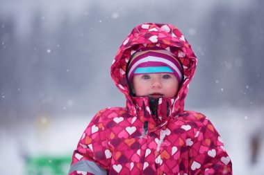 happy little girl  in winter outdoors clipart