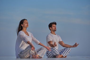 young couple practicing yoga clipart