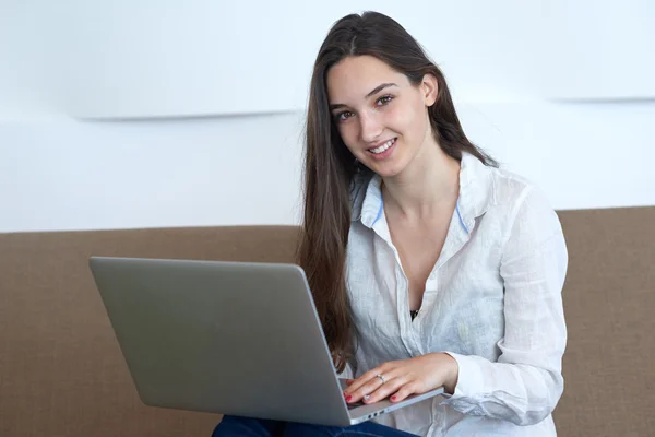Женщина расслабляется и работает на ноутбуке — стоковое фото