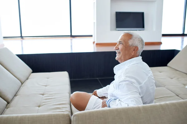 Senior man relaxing in sofa — Stock Photo, Image