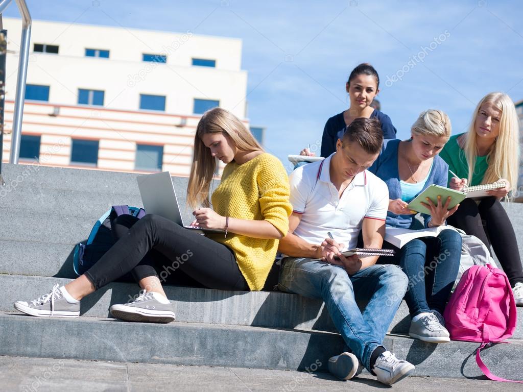 students outside sitting on steps
