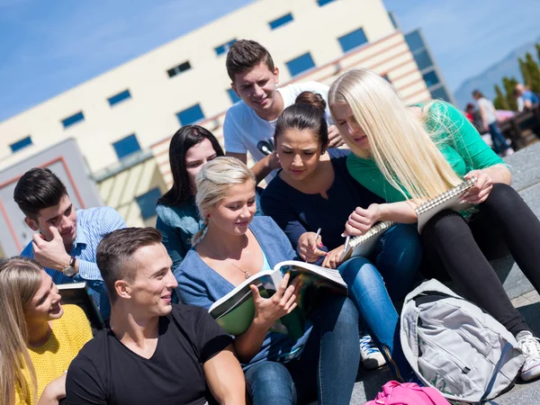 Studenti fuori seduti su gradini — Foto Stock