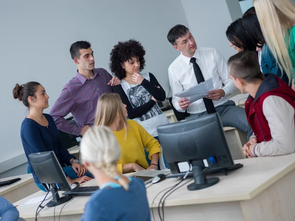 Group of students with teacher in classroom — Stock Photo, Image