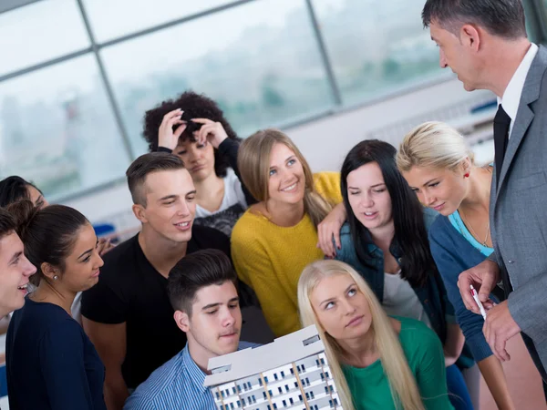 Group of students with teacher in classroom — Stock Photo, Image