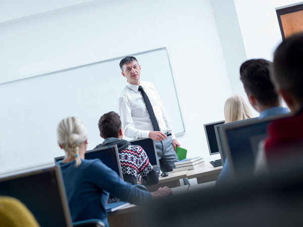 Students with teacher  in computer lab classroom