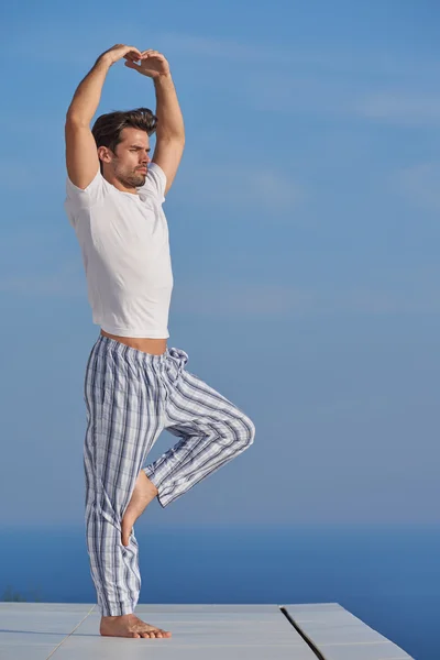 Young man practicing yoga — Stock Photo, Image