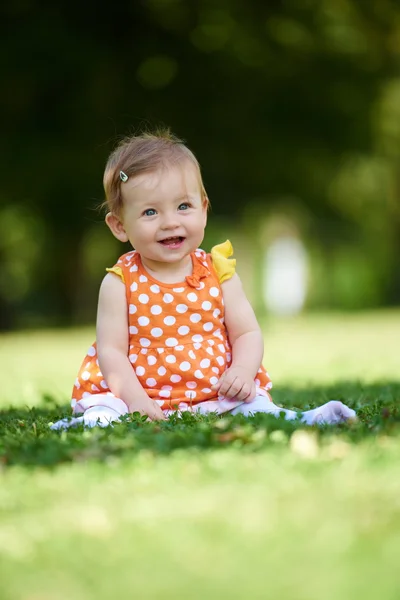 Baby kind zittend op het gras — Stockfoto