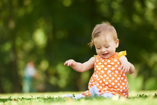 Baby child sitting on grass Stock Image