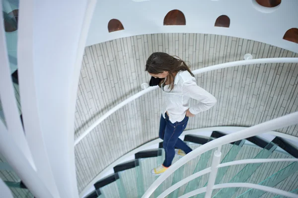 Woman walking on spiral stairs — Stock Photo, Image