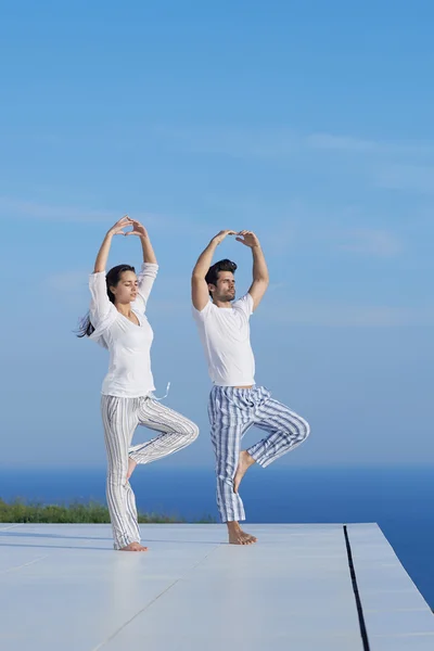 Young couple practicing yoga — Stock Photo, Image