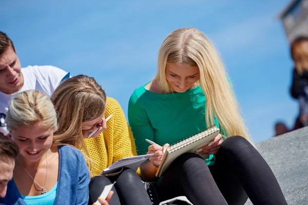 Studenten sitzen draußen auf Stufen — Stockfoto