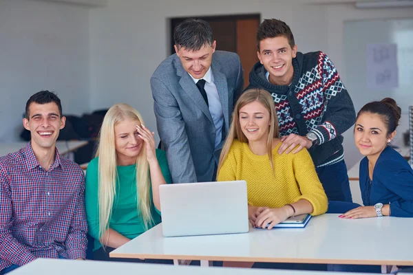 Students getting suppport from teacher — Stock Photo, Image