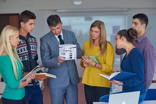 Students working with teacher — Stock Photo, Image