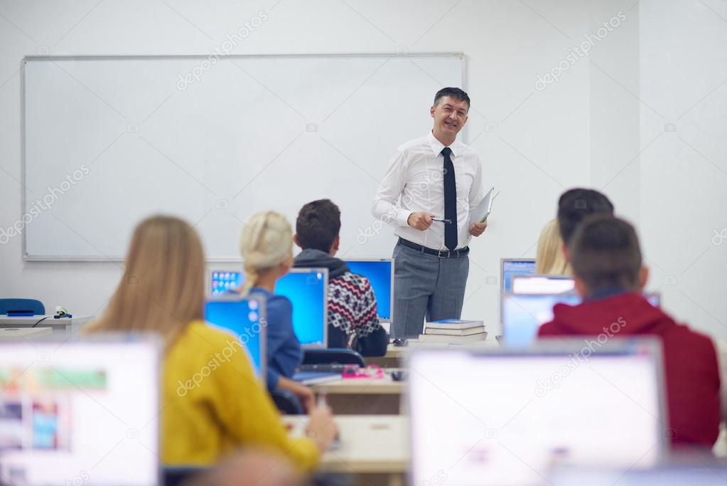 students with teacher in computer classroom
