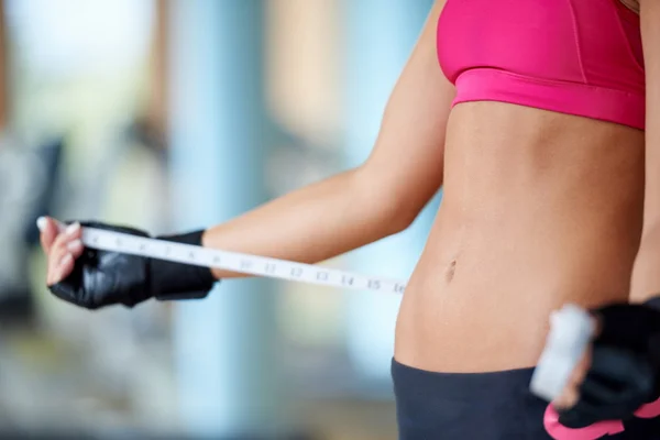Young fit woman measuring belly — Stock Photo, Image