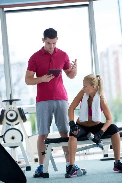 Woman with trainer exercise weights lifting — Stock Photo, Image