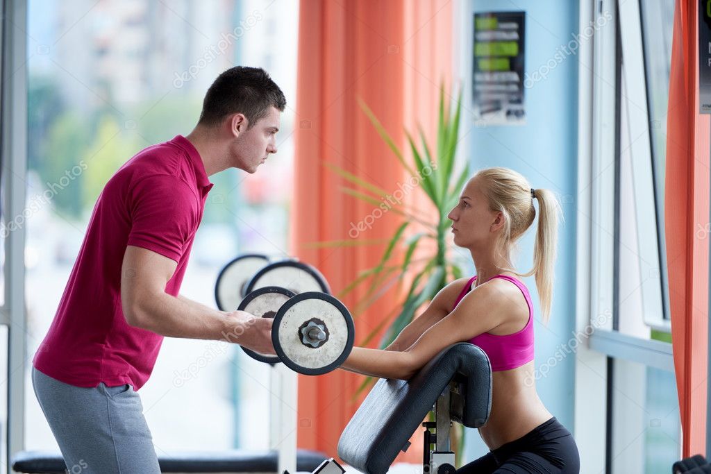 woman with trainer exercise weights lifting