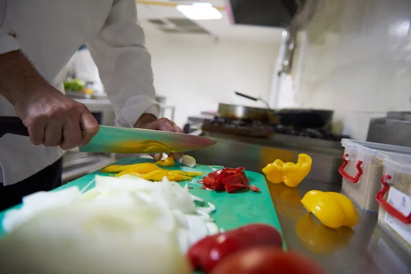 Chef dans la cuisine de l'hôtel tranchant des légumes avec couteau — Photo