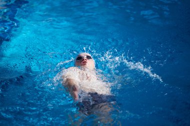 swimmer excercise on indoor swimming pool