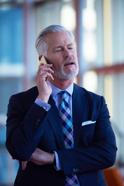 Starszy Biznesmen Rozmawiać Przez Telefon Komórkowy Nowoczesnym Jasnym Wnętrzu Biura — Zdjęcie stockowe