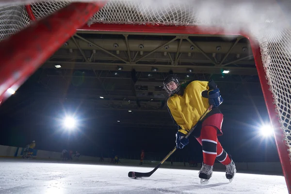 teen ice hockey player in action