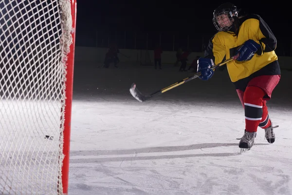 Adolescente jogador de hóquei no gelo em ação — Fotografia de Stock