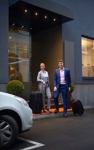 business people couple entering  hotel