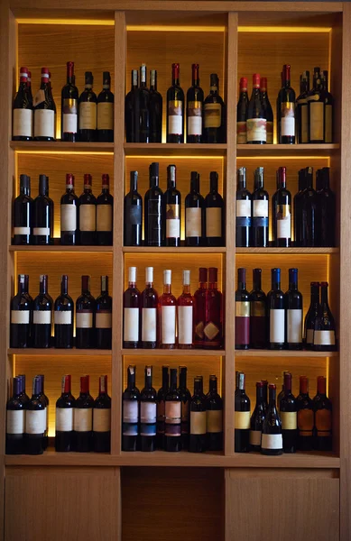 Vin flaskor på en trähylla. — Stockfoto