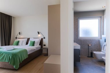 Lüks bir villada, özel bir yüzme havuzuna açılan büyük cam kapıları olan modern açık planlı oturma ve yemek odası, açık havada geniş ve zarif bir yaşam deneyimi sunuyor..