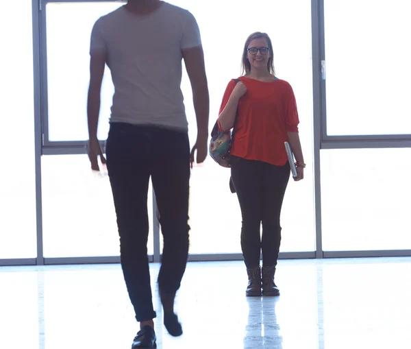 Student girl standing with laptop, people group passing by — Stock Photo, Image