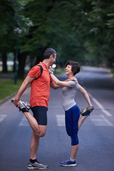 Joggingpaar streckt sich — Stockfoto
