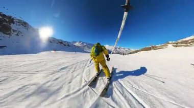 Parlak güneşli bir günde el değmemiş, karla kaplı bir dağ yamacında keyifli bir iniş yapın. Bu birinci şahıs bakış açısı kış sporlarının eğlencesini ve özgürlüğünü yansıtıyor.