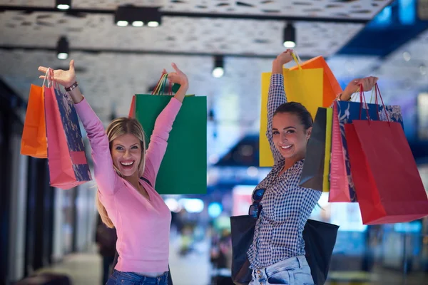 Happy young girls in shopping mall — Stock Photo, Image