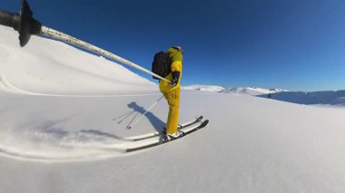 Elderly friends enjoy an exhilarating heliskiing and freeride tour, carving through fresh, deep powder snow in a stunning mountain landscape. Experience the joy of adventure under bright sun and clear
