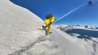 Experience the ultimate winter sport as a skier carves through fresh, deep powder snow during an exhilarating heliskiing tour down a majestic mountain.