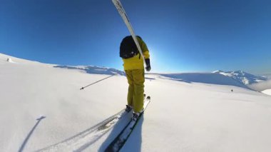 Experience the thrill of heliskiing down pristine mountain slopes. Enjoy deep powder snow and breathtaking winter landscapes under a clear blue sky, perfect for an unforgettable freeride adventure