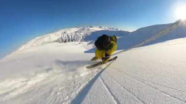 Experience the ultimate thrill of a heliskiing adventure, carving through untouched deep powder snow down a majestic mountain slope. Enjoy the pristine winter landscape under a clear blue sky