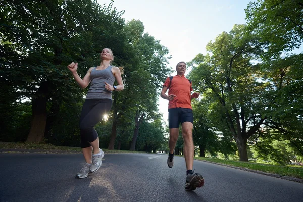 Couple jogging at early morning — Stock Photo, Image