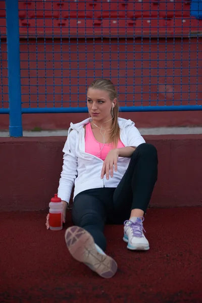 Sporty woman on athletic race track — Stock Photo, Image