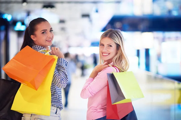 Happy young girls in shopping mall — Stock Photo, Image