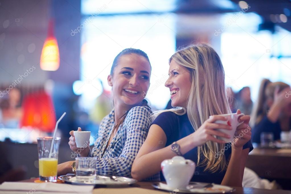 girls having cup of coffee in restaurant